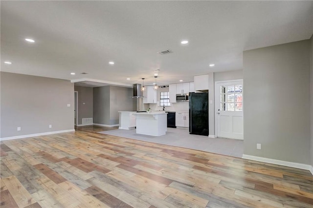 1112 Druid Dr, Mobile, AL 36618 - unfurnished living room featuring light wood finished floors, plenty of natural light, recessed lighting, and baseboards