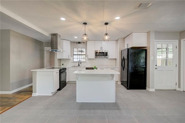 1112 Druid Dr, Mobile, AL 36618 - kitchen with black appliances, exhaust hood, baseboards, white cabinetry, and light countertops