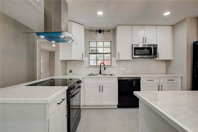 1112 Druid Dr, Mobile, AL 36618 - kitchen with black appliances, island range hood, a sink, decorative backsplash, and a peninsula