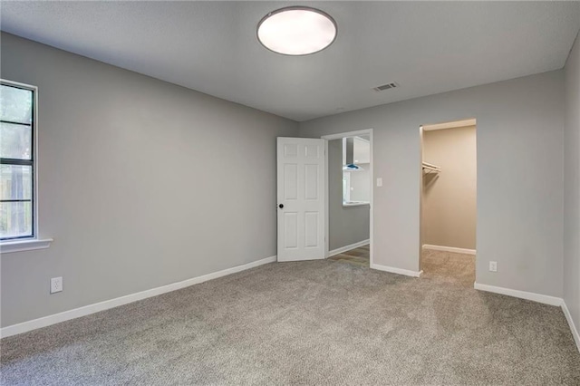 1112 Druid Dr, Mobile, AL 36618 - unfurnished bedroom featuring carpet floors, a walk in closet, baseboards, and a closet