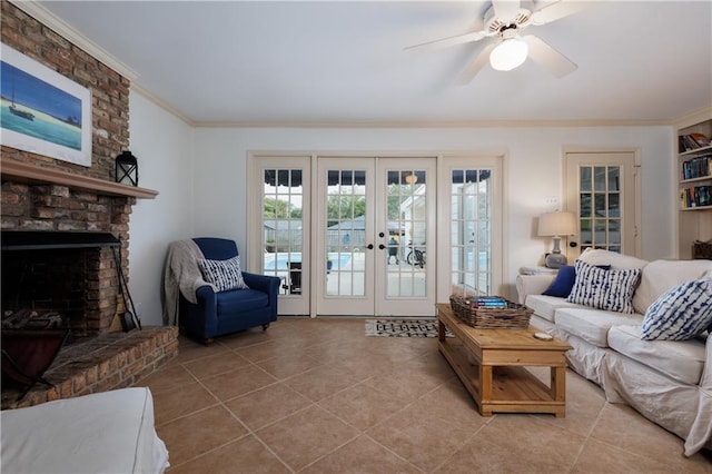 living room featuring a brick fireplace, ceiling fan, light tile patterned floors, and french doors