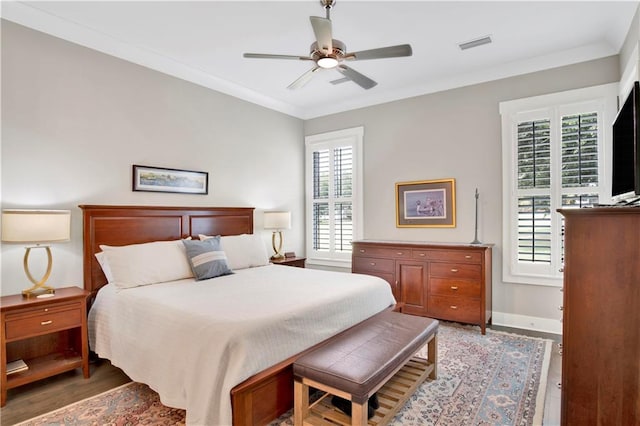 bedroom with ceiling fan, ornamental molding, and hardwood / wood-style floors