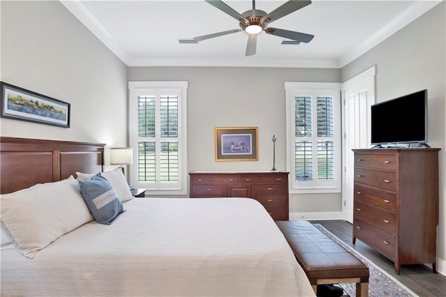 bedroom with crown molding, hardwood / wood-style floors, and ceiling fan