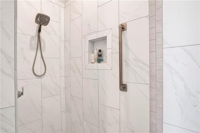 bathroom with tiled shower