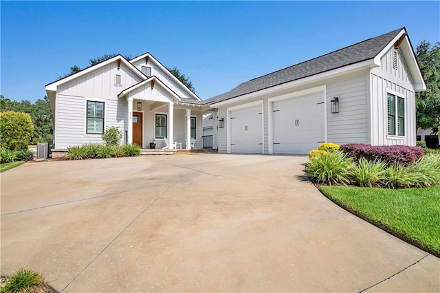 view of front of property featuring cooling unit and a garage