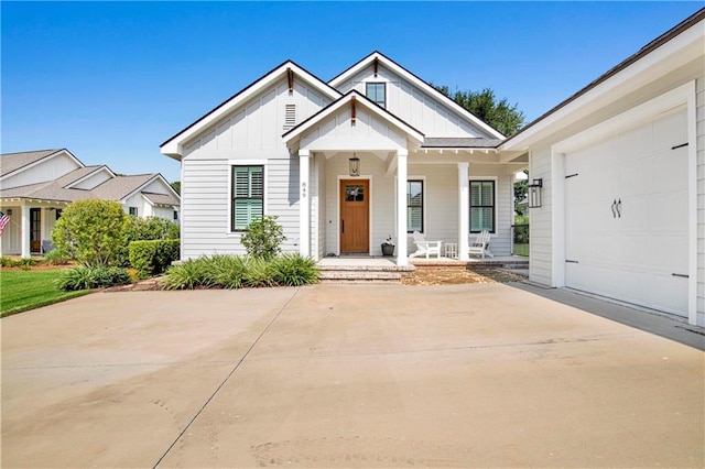 view of front of home featuring a porch and a garage