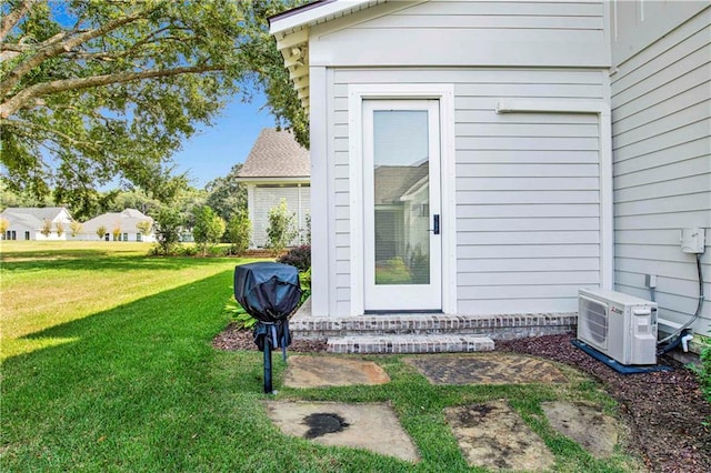 property entrance featuring ac unit and a lawn