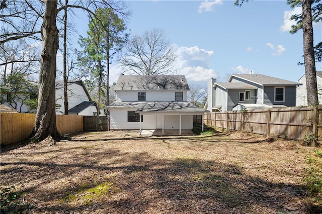 back of property featuring a fenced backyard and a patio area