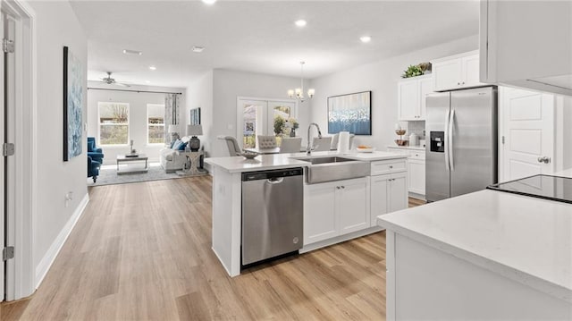 7320 Hawkins Mnr S, Mobile, AL 36695 - kitchen with stainless steel appliances, recessed lighting, light countertops, light wood-type flooring, and a kitchen island with sink