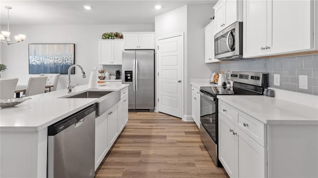 7320 Hawkins Mnr S, Mobile, AL 36695 - kitchen featuring stainless steel appliances, recessed lighting, a chandelier, light wood-style floors, and white cabinetry