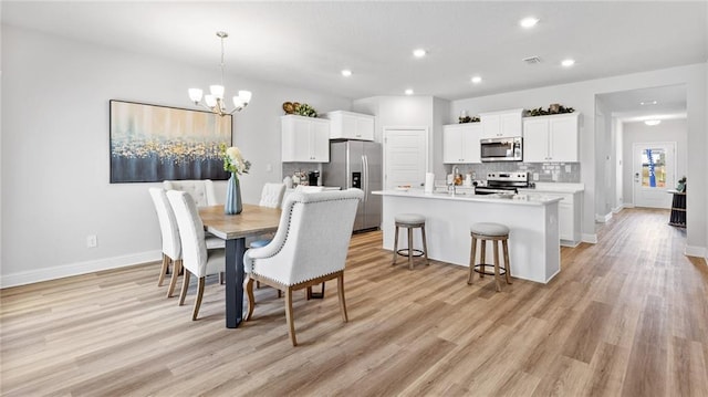 7320 Hawkins Mnr S, Mobile, AL 36695 - dining space featuring a chandelier, light wood-style flooring, and recessed lighting
