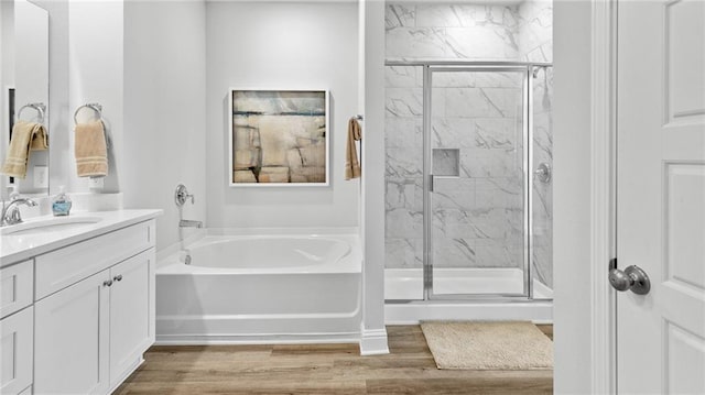 7320 Hawkins Mnr S, Mobile, AL 36695 - full bath with vanity, a garden tub, a marble finish shower, and wood finished floors