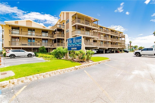 view of property featuring uncovered parking