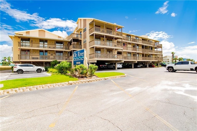 view of property featuring uncovered parking