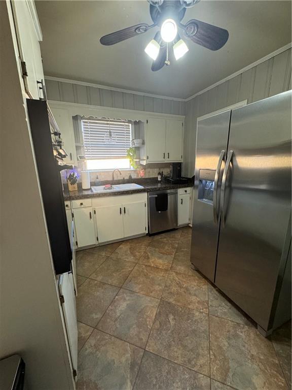 kitchen featuring white cabinets, crown molding, sink, ceiling fan, and appliances with stainless steel finishes