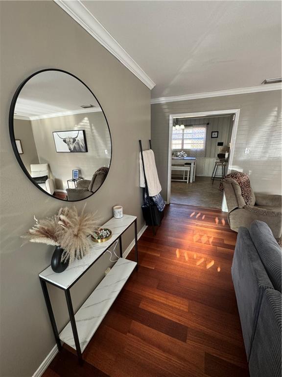 hall featuring crown molding and dark hardwood / wood-style floors