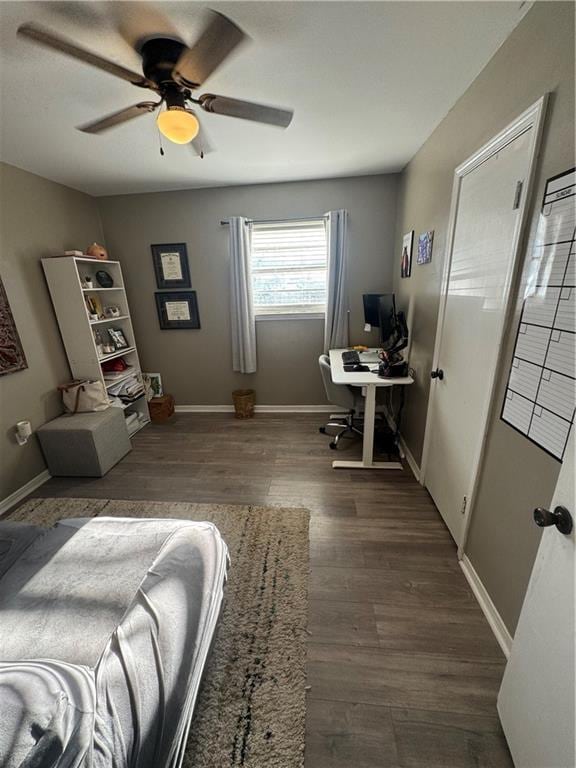 bedroom with dark hardwood / wood-style floors and ceiling fan