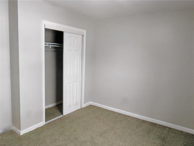 unfurnished bedroom featuring carpet floors and a closet