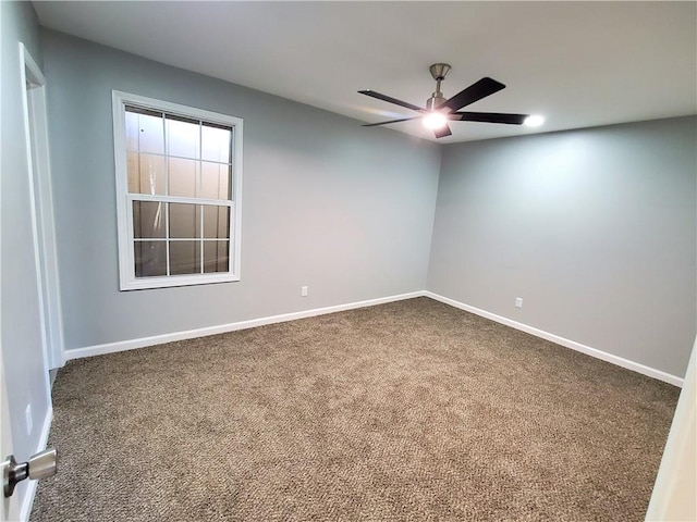 unfurnished room with ceiling fan and carpet