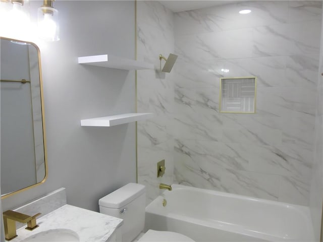 full bathroom with vanity, tiled shower / bath combo, and toilet