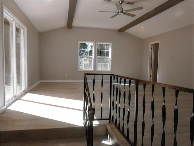 stairway with wood-type flooring and vaulted ceiling with beams