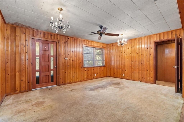 unfurnished living room featuring carpet and an inviting chandelier