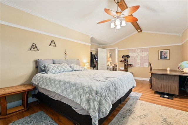 bedroom with ornamental molding, vaulted ceiling with beams, hardwood / wood-style floors, and ceiling fan