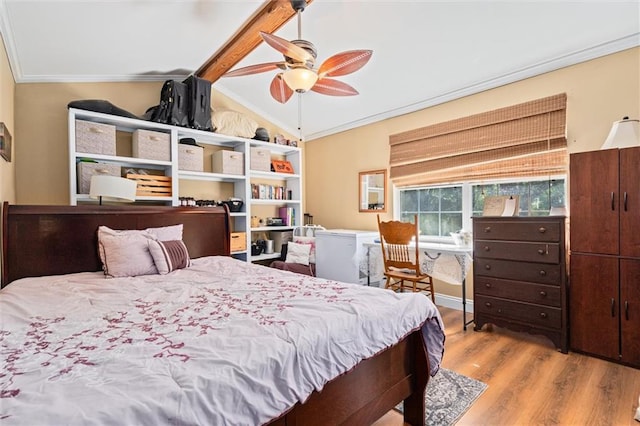 bedroom with ceiling fan, ornamental molding, lofted ceiling with beams, and light wood-type flooring