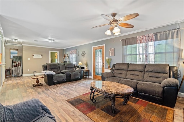 living room with ceiling fan, ornamental molding, and light wood-type flooring