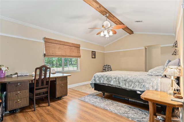 bedroom featuring ornamental molding, vaulted ceiling with beams, and light hardwood / wood-style flooring