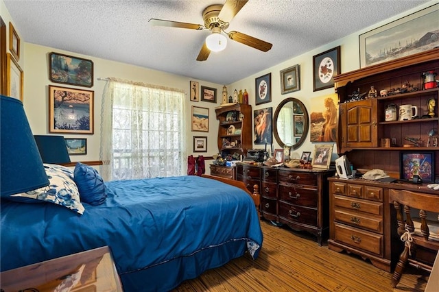 3425 Poe Rd S, Chunchula, AL 36521 - bedroom featuring wood finished floors, a textured ceiling, a ceiling fan, and an office area