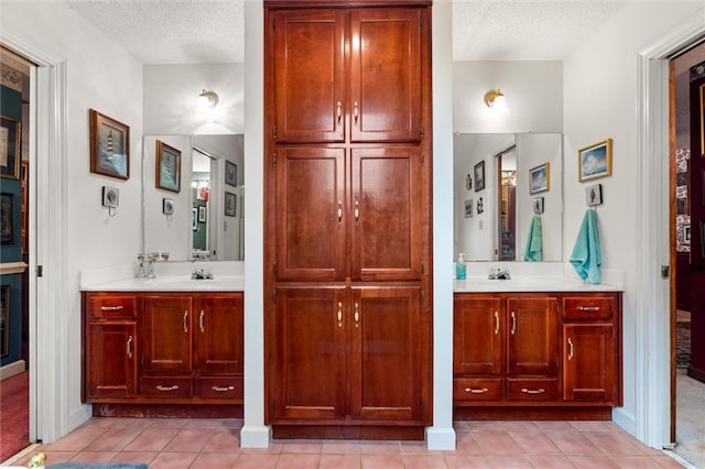 3425 Poe Rd S, Chunchula, AL 36521 - full bathroom featuring a textured ceiling, two vanities, and tile patterned flooring