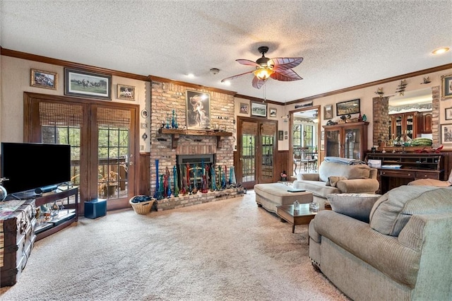 3425 Poe Rd S, Chunchula, AL 36521 - carpeted living room featuring ceiling fan, a textured ceiling, plenty of natural light, ornamental molding, and a brick fireplace