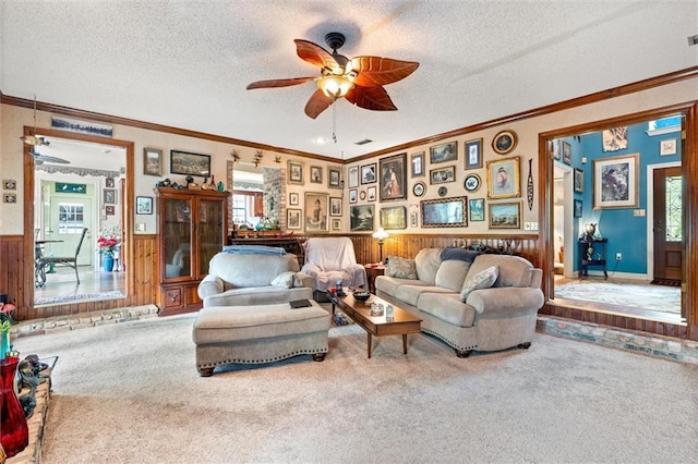 3425 Poe Rd S, Chunchula, AL 36521 - living room featuring wainscoting, carpet floors, a textured ceiling, healthy amount of natural light, and a ceiling fan