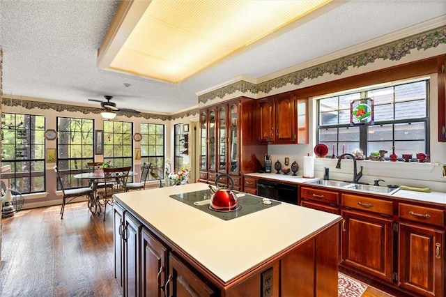 3425 Poe Rd S, Chunchula, AL 36521 - kitchen with black dishwasher, electric cooktop, wood finished floors, dark brown cabinets, and light countertops
