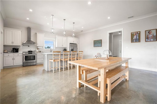 11531 Schmidt Ln S, Mobile, AL 36695 - kitchen featuring stainless steel appliances, wall chimney range hood, concrete floors, white cabinets, and recessed lighting