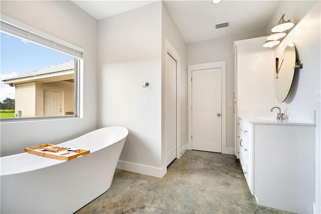 11531 Schmidt Ln S, Mobile, AL 36695 - full bathroom featuring vanity, a freestanding bath, plenty of natural light, and concrete floors