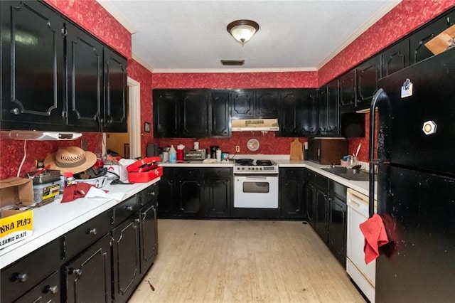 kitchen with ornamental molding, under cabinet range hood, dark cabinetry, and white appliances