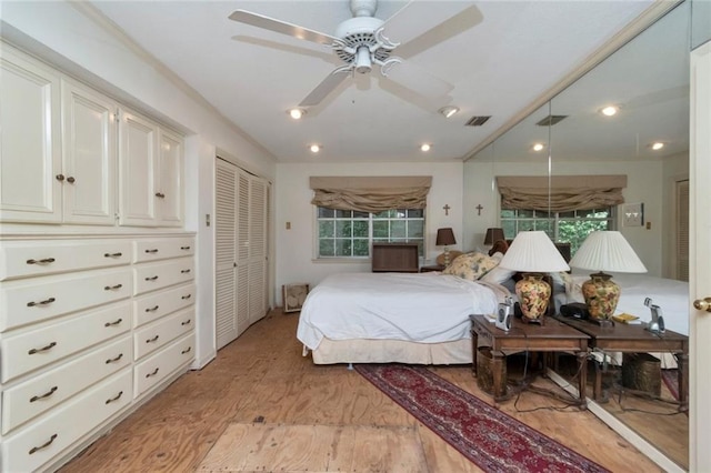 bedroom with visible vents, light wood finished floors, and ceiling fan
