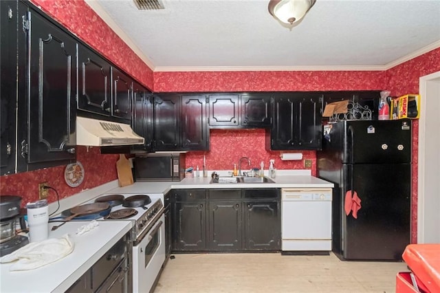 kitchen featuring wallpapered walls, under cabinet range hood, light countertops, a sink, and black appliances