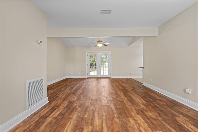 unfurnished room featuring beamed ceiling, ceiling fan, dark hardwood / wood-style flooring, and french doors