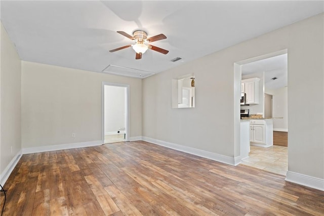 empty room featuring ceiling fan and light hardwood / wood-style floors