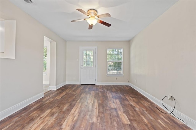 spare room featuring ceiling fan and dark wood-type flooring