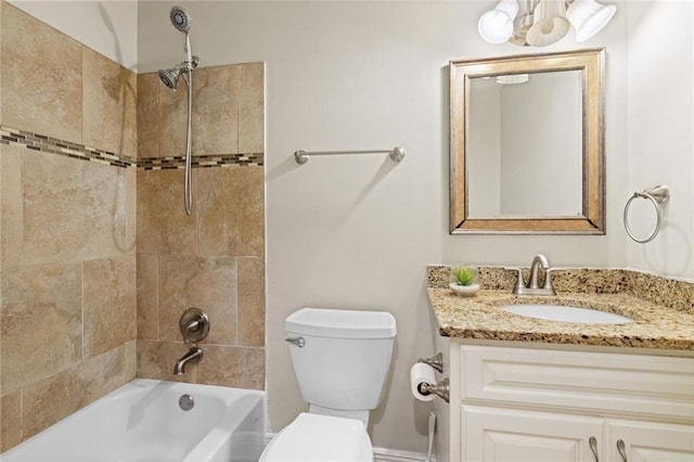 full bathroom with tiled shower / bath combo, toilet, and vanity