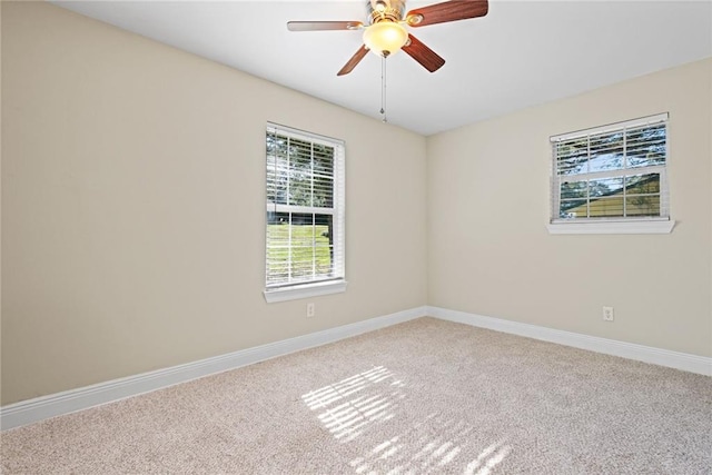 carpeted spare room featuring ceiling fan