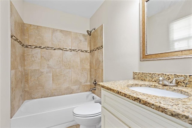 full bathroom with vanity, toilet, and tiled shower / bath