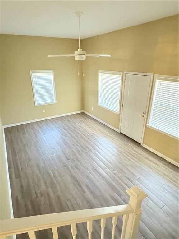 unfurnished dining area featuring ceiling fan, a healthy amount of sunlight, and hardwood / wood-style floors