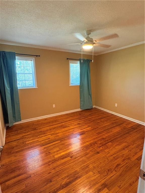 empty room featuring crown molding, hardwood / wood-style floors, a textured ceiling, and ceiling fan