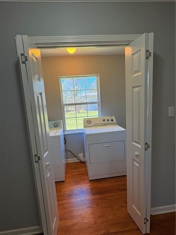 clothes washing area featuring dark hardwood / wood-style flooring and washing machine and dryer