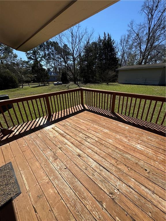 wooden deck featuring a yard